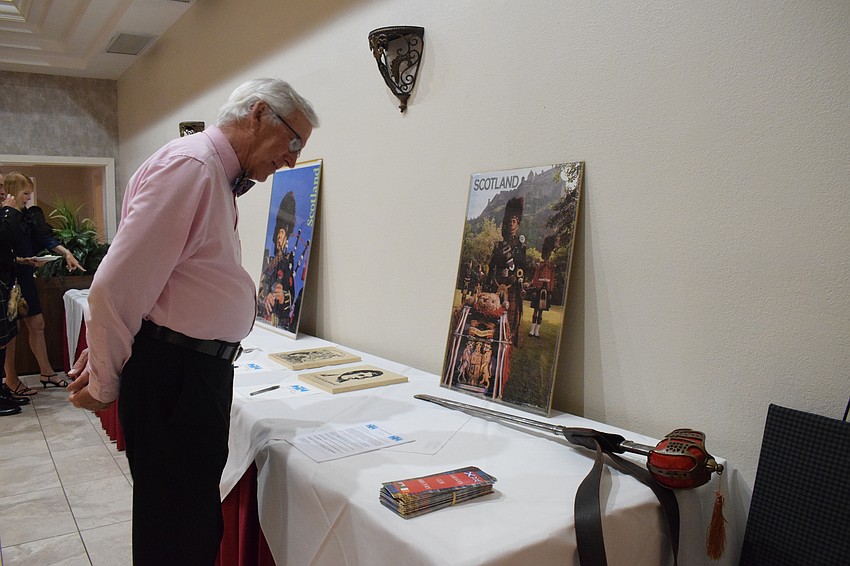 James Anderson, who is visiting from Pennsylvania, looks at the items available in the silent auction.