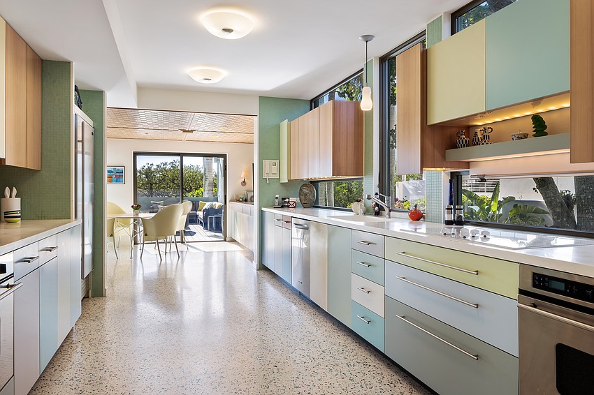 The pastel scheme continues from the exterior into the kitchen.