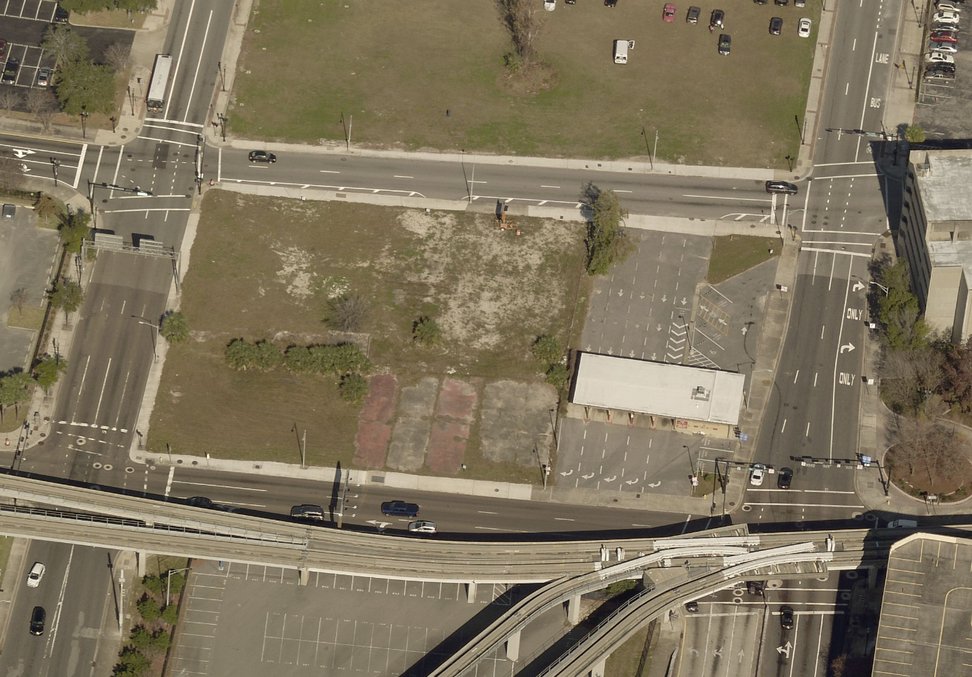 A city aerial view of the property shows a  former drive-thru bank branch at the site.