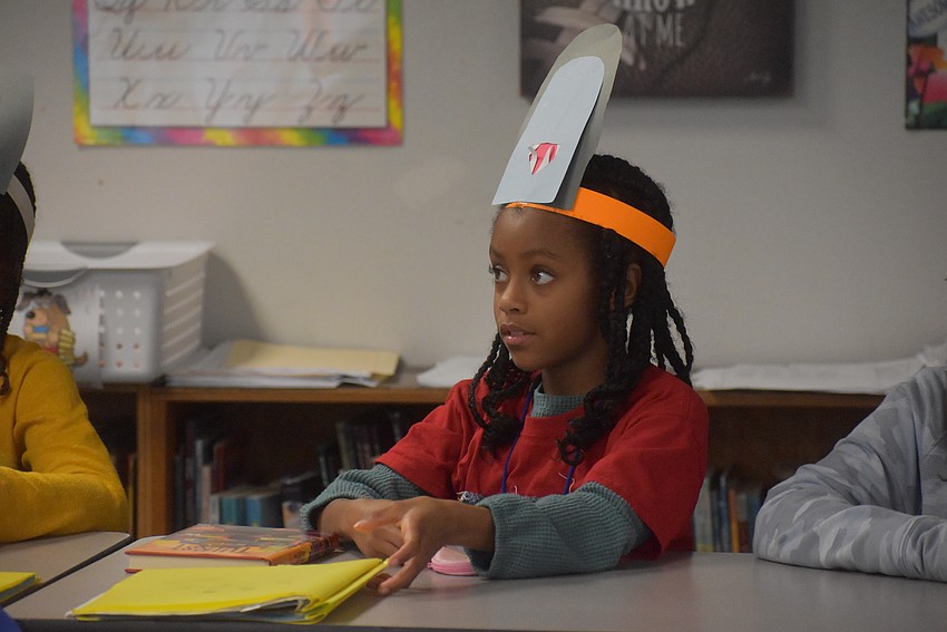 Ava Everett listens to Mayor Kyle Battie read.