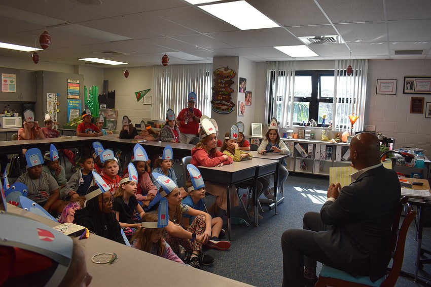 Mayor Kyle Battie reads to the fourth grade students.