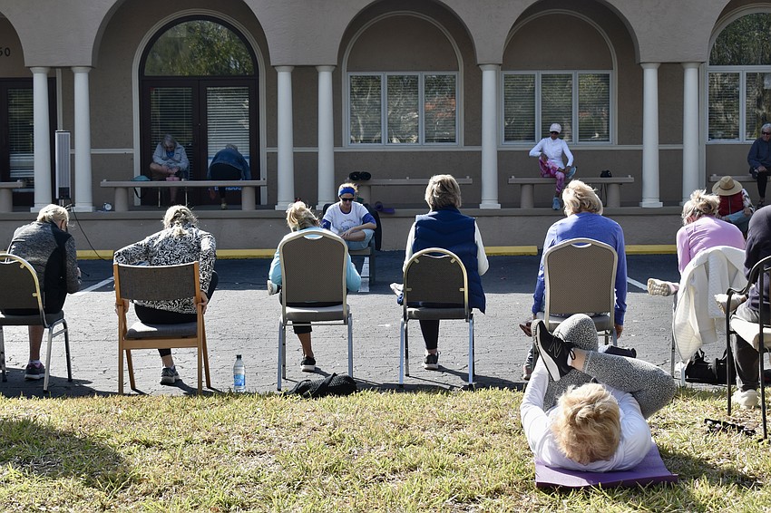 TPC CEO Suzy Brenner leads the crowd through some stretches.