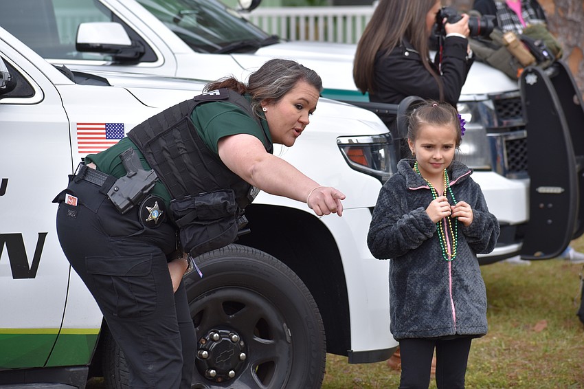Manatee County Sheriff's Office employee Skylar Clark gives some advice to Creekwood 6-year-old Isabella Wildt.