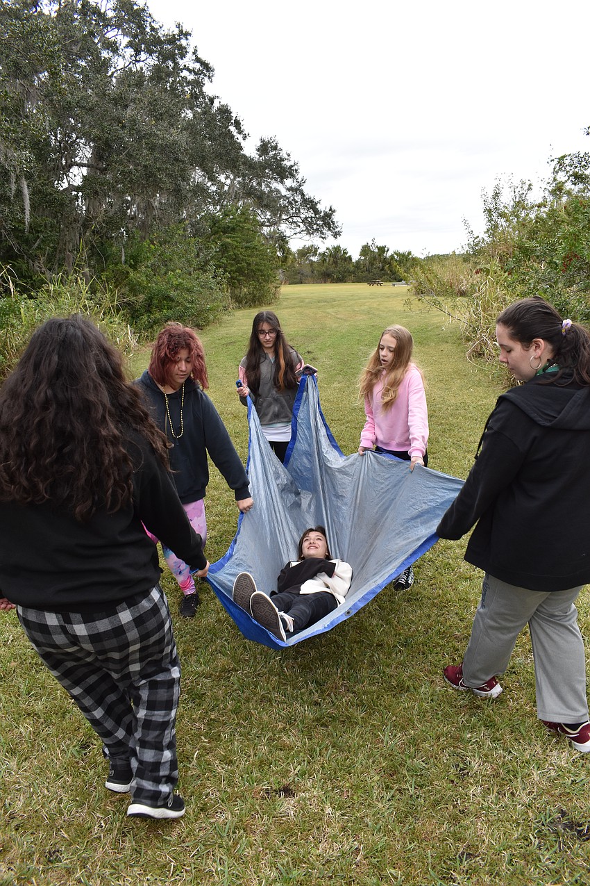 Lakewood Ranch 14-year-old Reese Gurski gets a turn to play the injured person as she is carried by Bradenton 13-year-old Jennifer Lopez, Creekwood 15-year-old Isabella Oliveira, Oneco 14-year-old Erika Garcia, Palmetto 12-year-old Lacy Kimbrell, and Ellenton 13-year-old Brooke Harden.