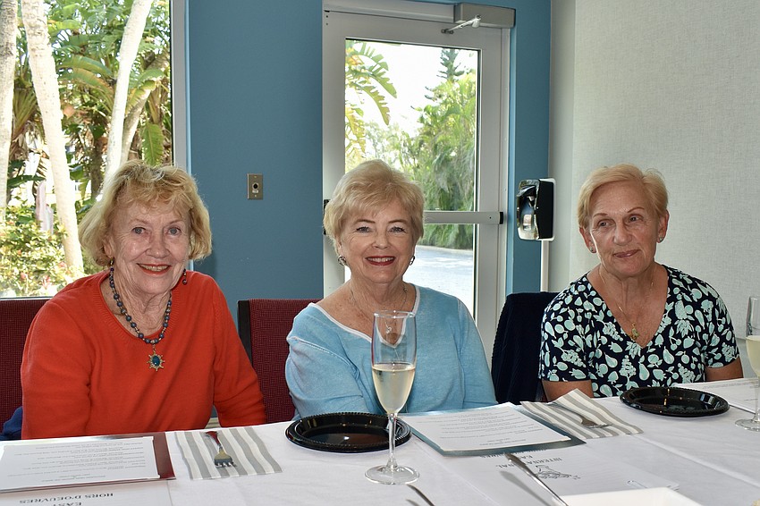 Sue Reese, Jamie Engel and Ginger Stefan sample some wine before the appetizers are served.