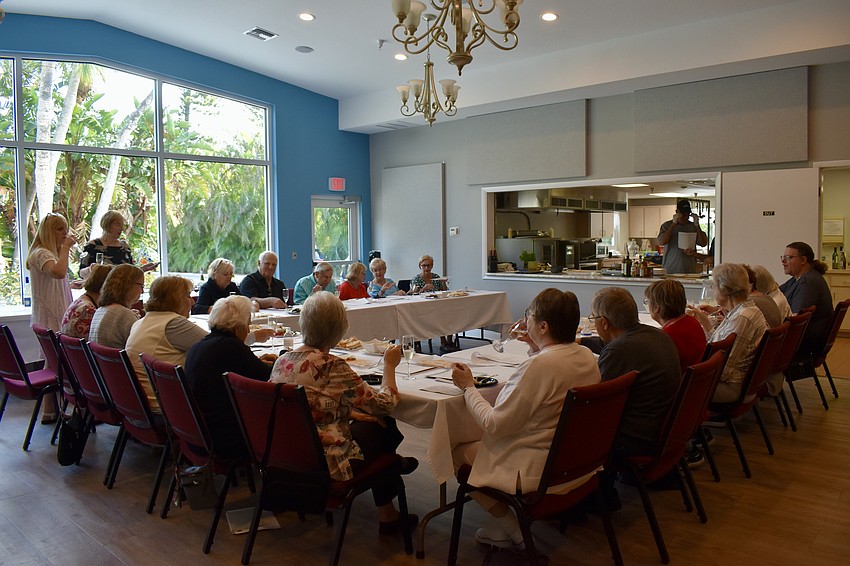 Longboat Island Chapel members taste appetizers and sample wines at a cooking demonstration.