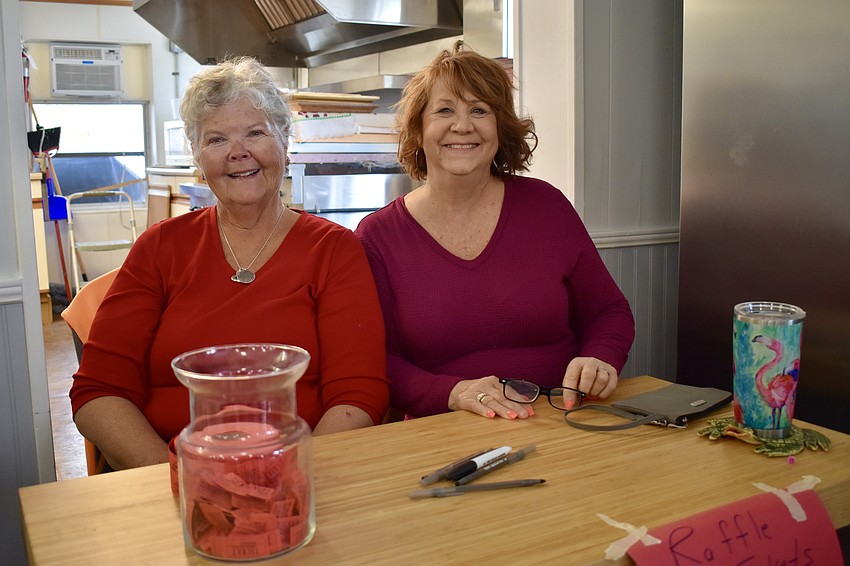 Patti Helminski and Kathi Clements selling raffle tickets.