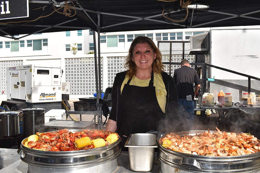 Amy Watson serves seafood at the 7th Annual Sarasota Seafood and Music Festival.