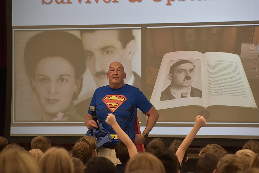 Steve Koenig revealed his superman shirt under his button-down as he asks Southside Elementary students what their favorite superhero is.