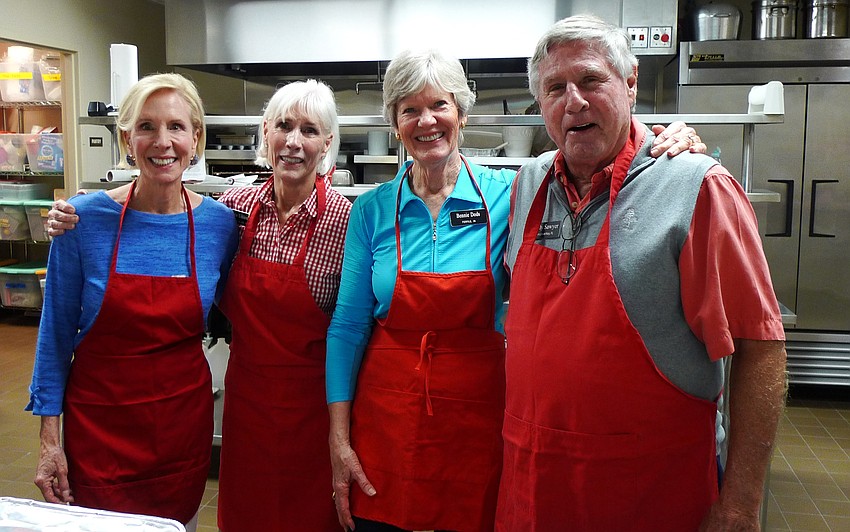 Sally Rauch, LuƟe Uihlein, Bennie Dods and Andy Sawyer get ready to serve dinner.