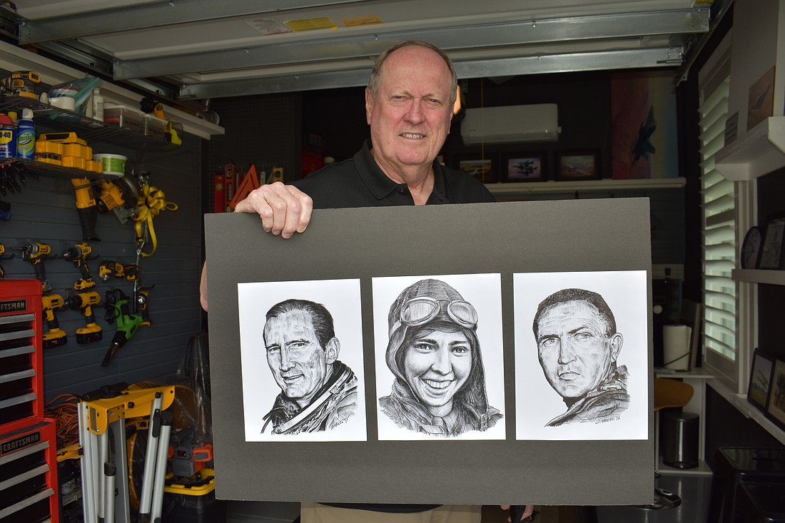 Lakewood Ranch's Don Malko, who won a trip for two to the Super Bowl, shows off his drawings of significant members of the aerospace industry.