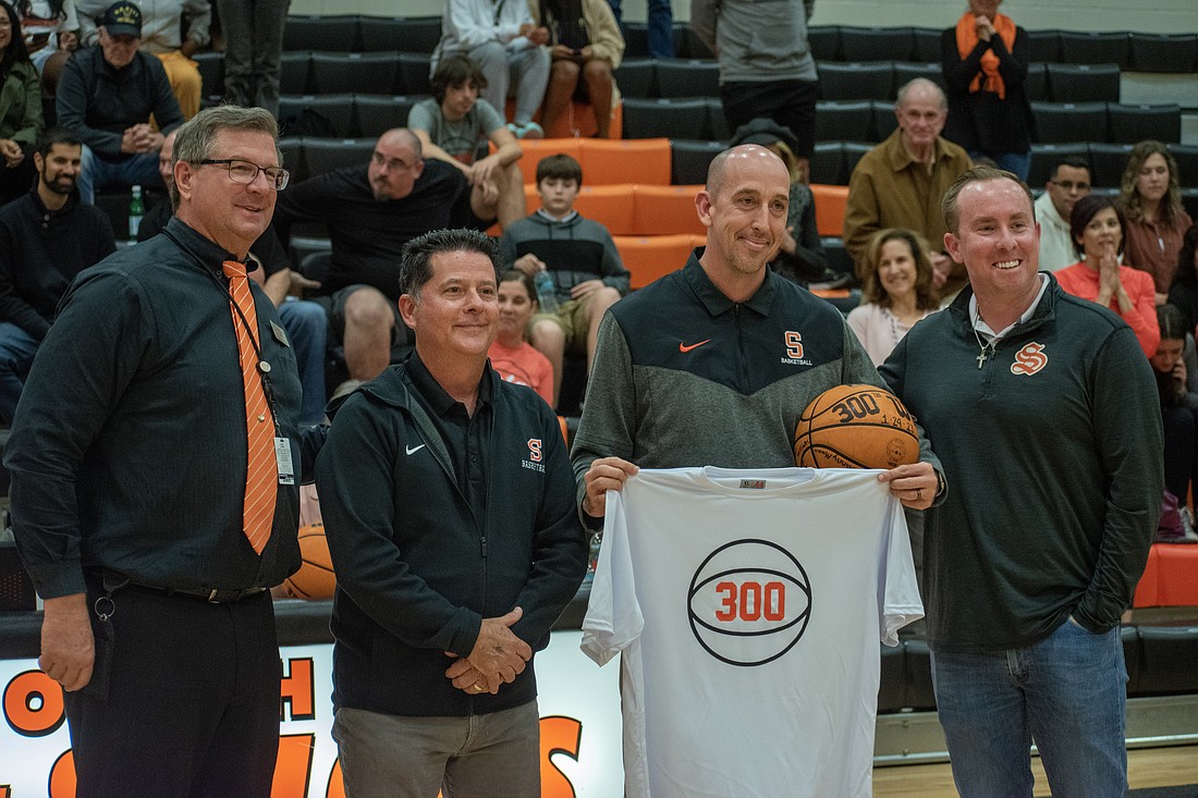 B.J. Ivey was presented by Sarasota High with a commemorative basketball and shirt in recognition of his 300th varsity win.