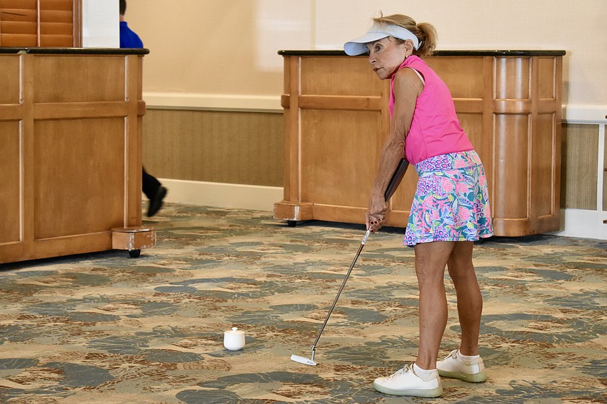 Betsy Granite takes a putt.