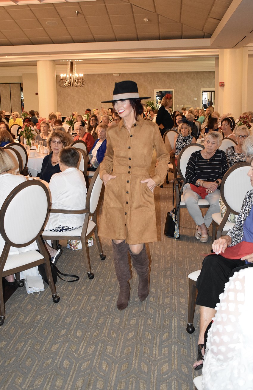 Palm Aire's Katherine Pike's outfit includes knee-high boots.