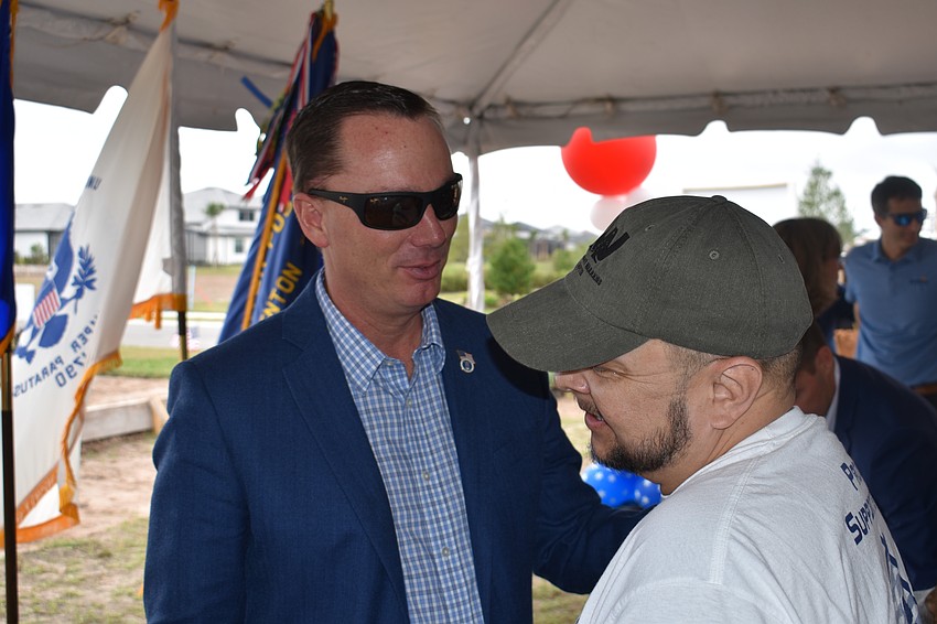 Rep. Tommy Gregory, House District 73, visits with Army Sgt. Lucio Gaytan during the ceremony.