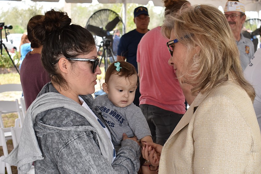 Ivette Gaytan and her daughter 1-year-old Lyanna Gaytan, visit with Manatee County Commission Vanessa Baugh.