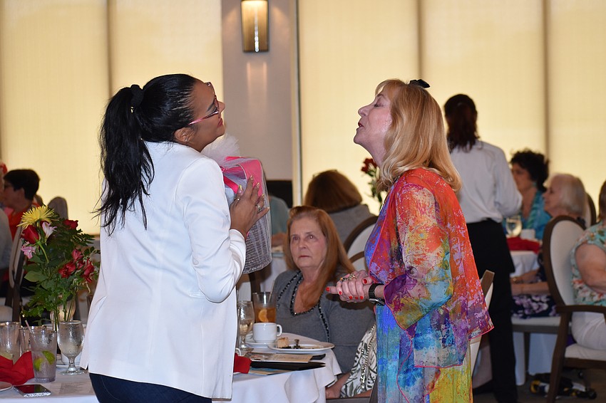 Viarua Centeno receives a raffle gift from fashion show co-chair Michelle Crabtree.