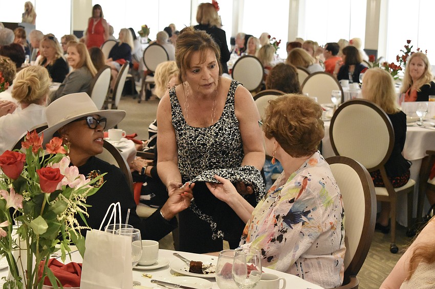 Sarasota's Brenda Belsito, model Debbi Fredericks, and Palm Aire's Ellen Marsey discuss Fredericks' attire.