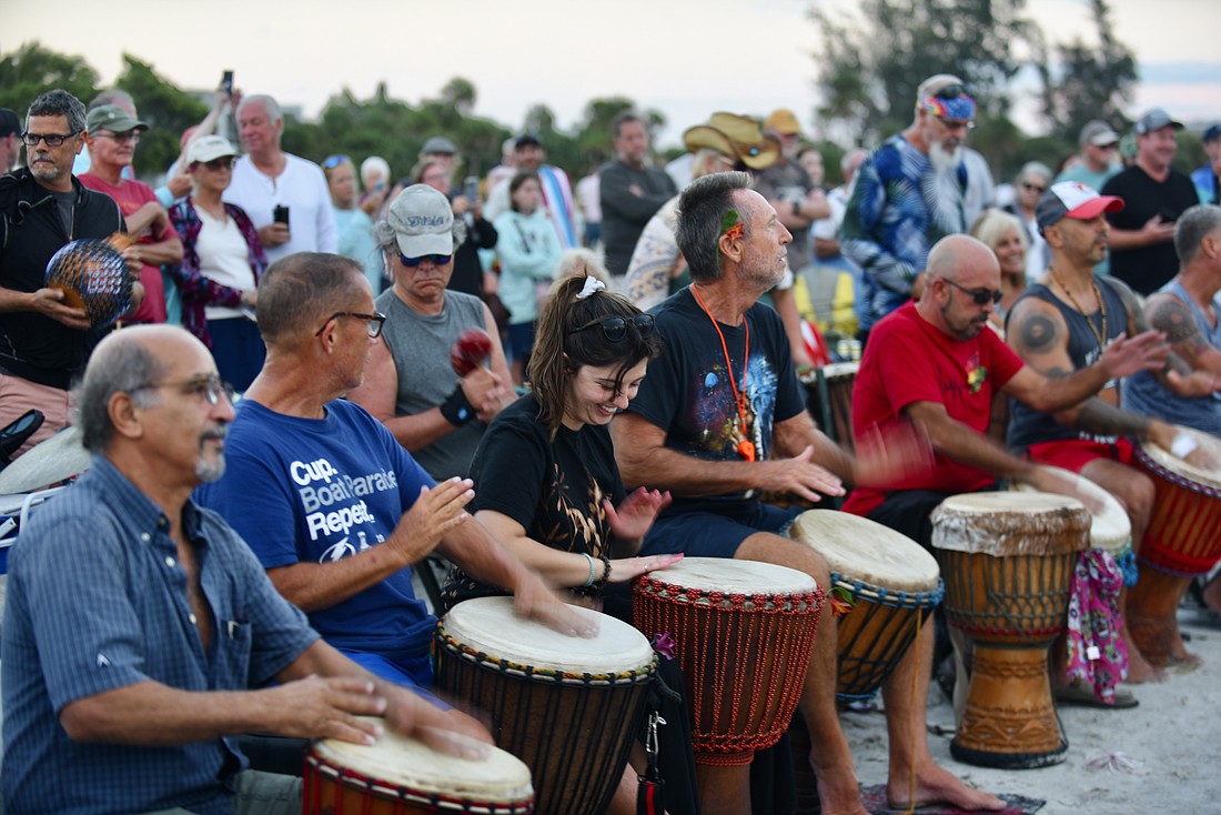 Drum circle newbie Julia Clark (center) bangs her worries away among the usual cadre of characters.
