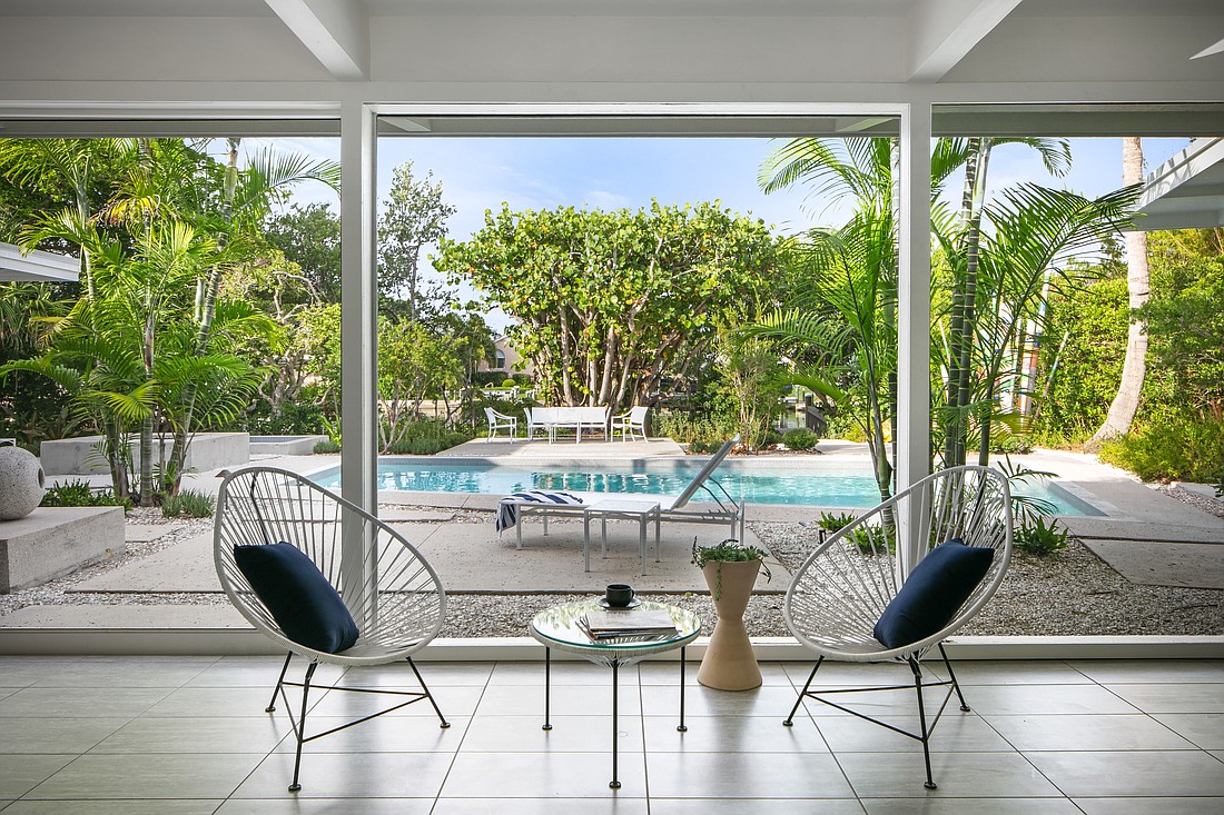 The lanai overlooks a pool and a small grove of mangroves and sea grape lining the bayou.