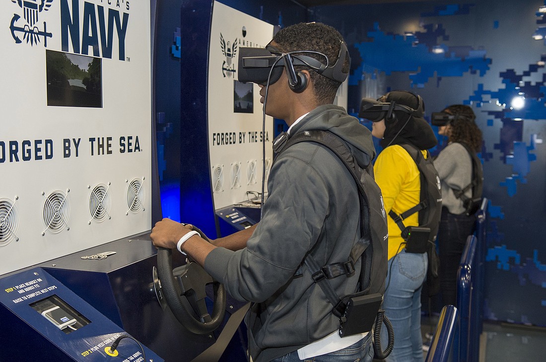 Students participate in the Navy’s virtual reality asset, the Nimitz, during the Navy Recruiting Command's “Swarm” Orlando evolution.