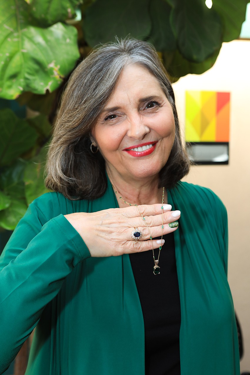 Cindy Kaiser highlights an emerald diamond up for raffle.