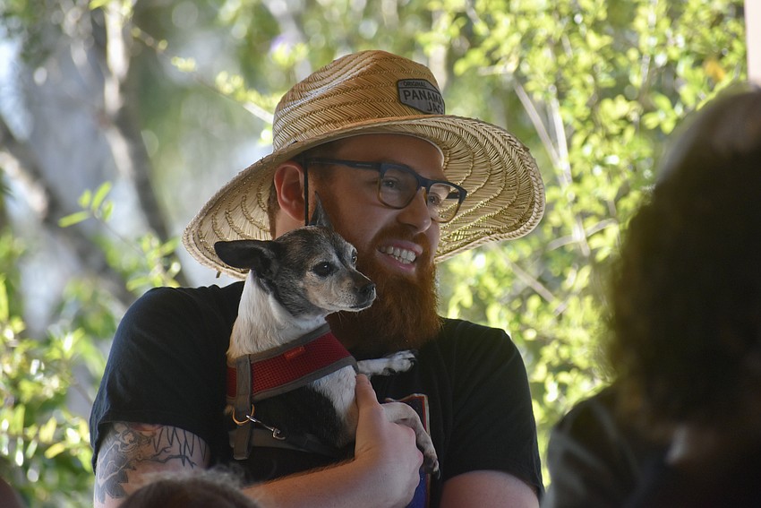 Andrew Sampson and his dog Cudi listen and sing along with the students.