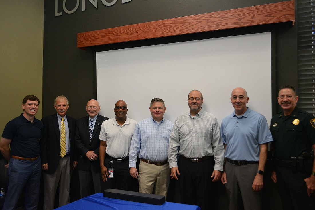 Brad Johnson, Howard Tipton, Ed Lavallee, Mark Cunningham, Johnathan Lewis, Tom Harmer, Steve Botelho and Sheriff Kurt Hoffman gathered at Harmer's retirement party.