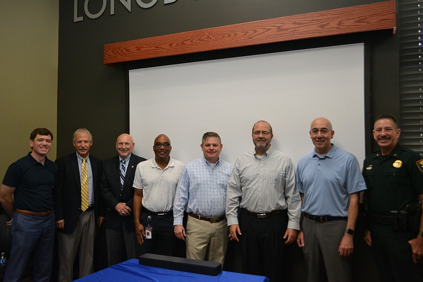 Brad Johnson, Howard Tipton, Ed Lavallee, Mark Cunningham, Johnathan Lewis, Tom Harmer, Steve Botelho and Sheriff Kurt Hoffman gathered at Harmer's retirement party.