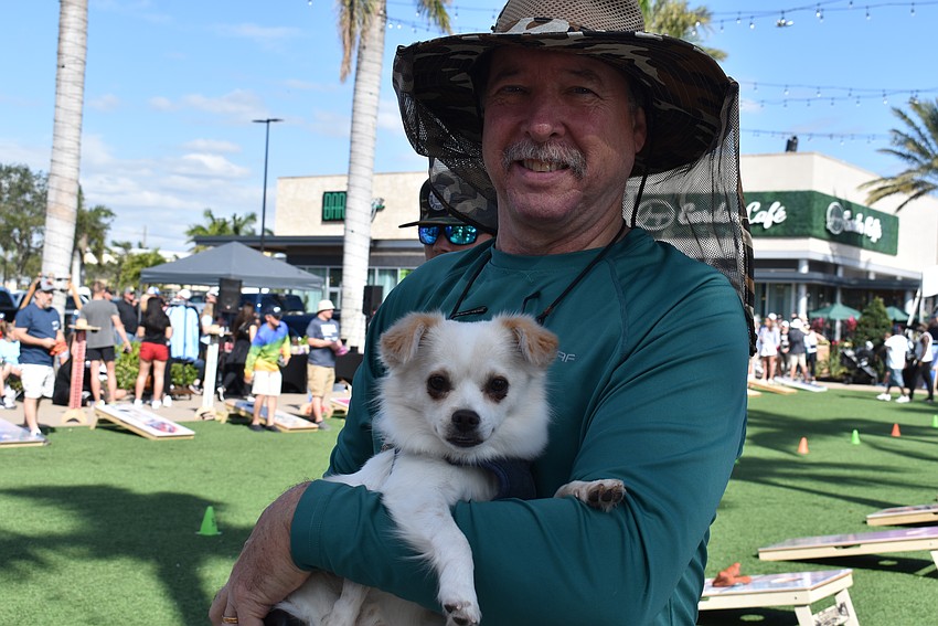 Sam Monroe with his dog Blaze come out to support the Dederick family.