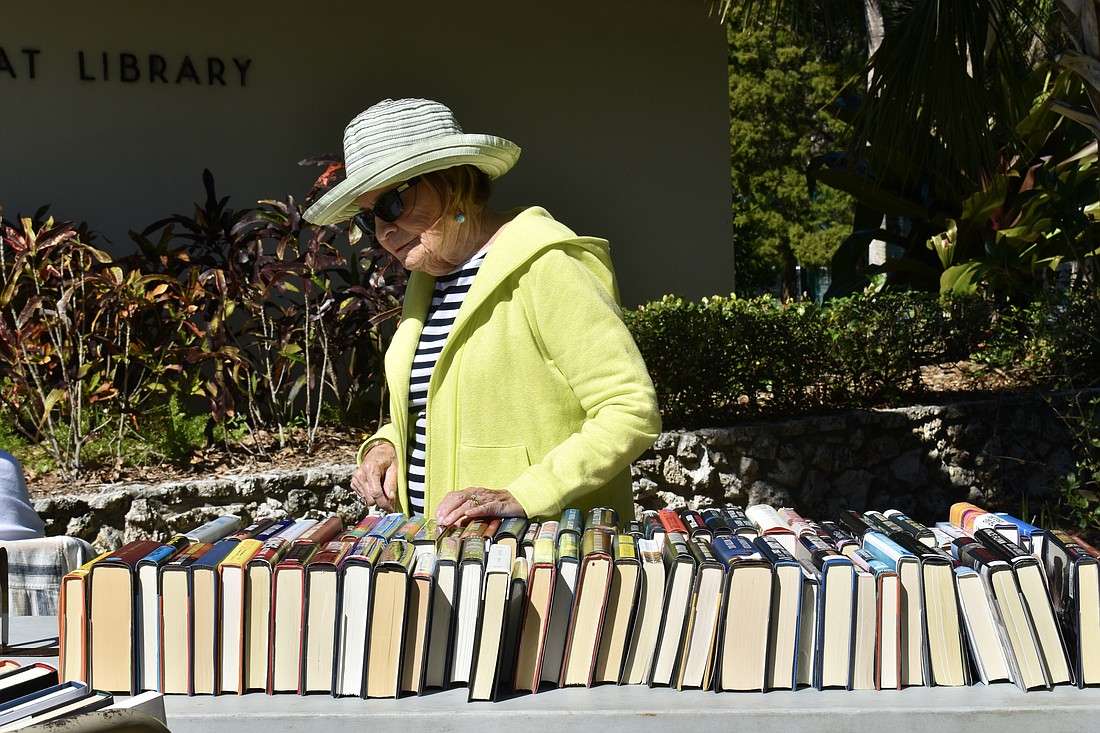 Barbara Claudy shops at the Longboat Library book sale on Saturday.