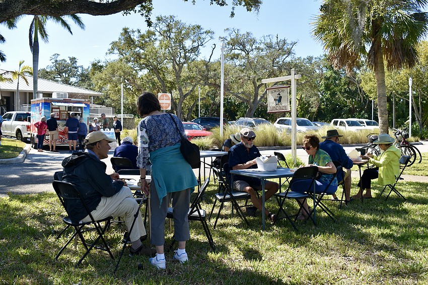 Shoppers leaf through books and dine on lobster.