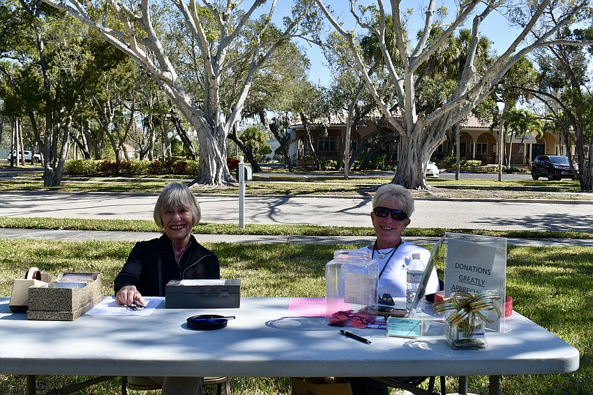 Volunteers Judy Herbert and Jane Macedonia work the checkout.