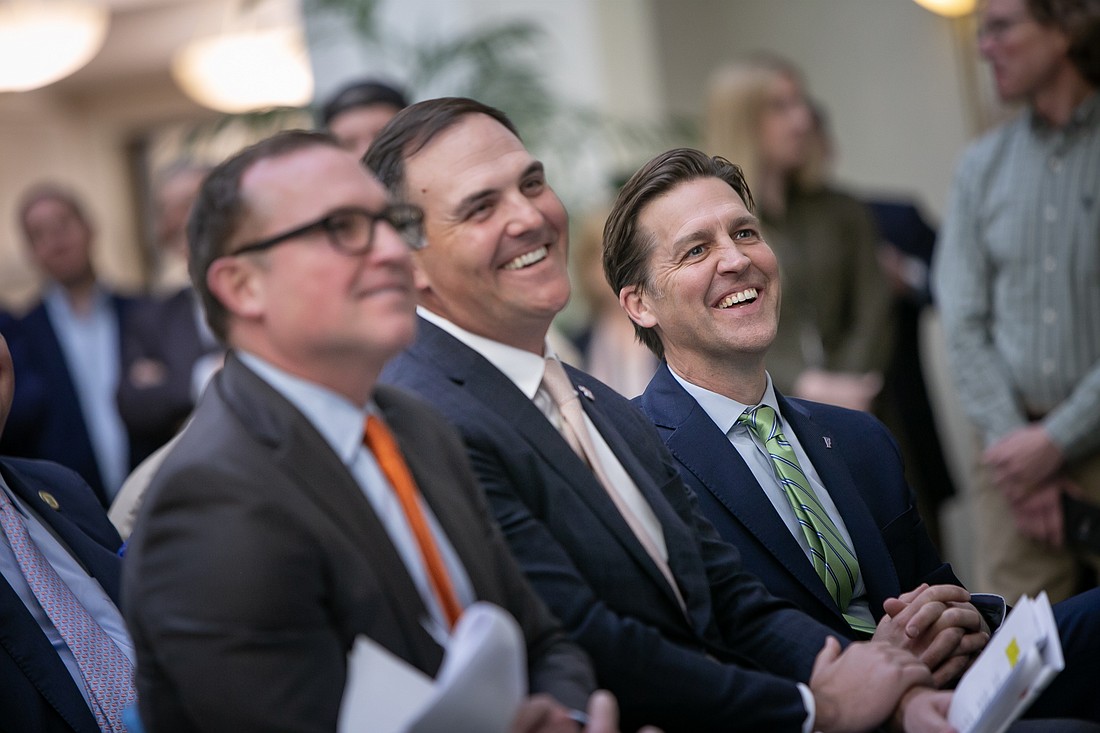 Jacksonville Mayor Lenny Curry, University of Florida Board of Trustees appointee Patrick Zalupski and UF President Ben Sasse watch at the news conference on plans to explore a new UF graduate campus in Jacksonville.
