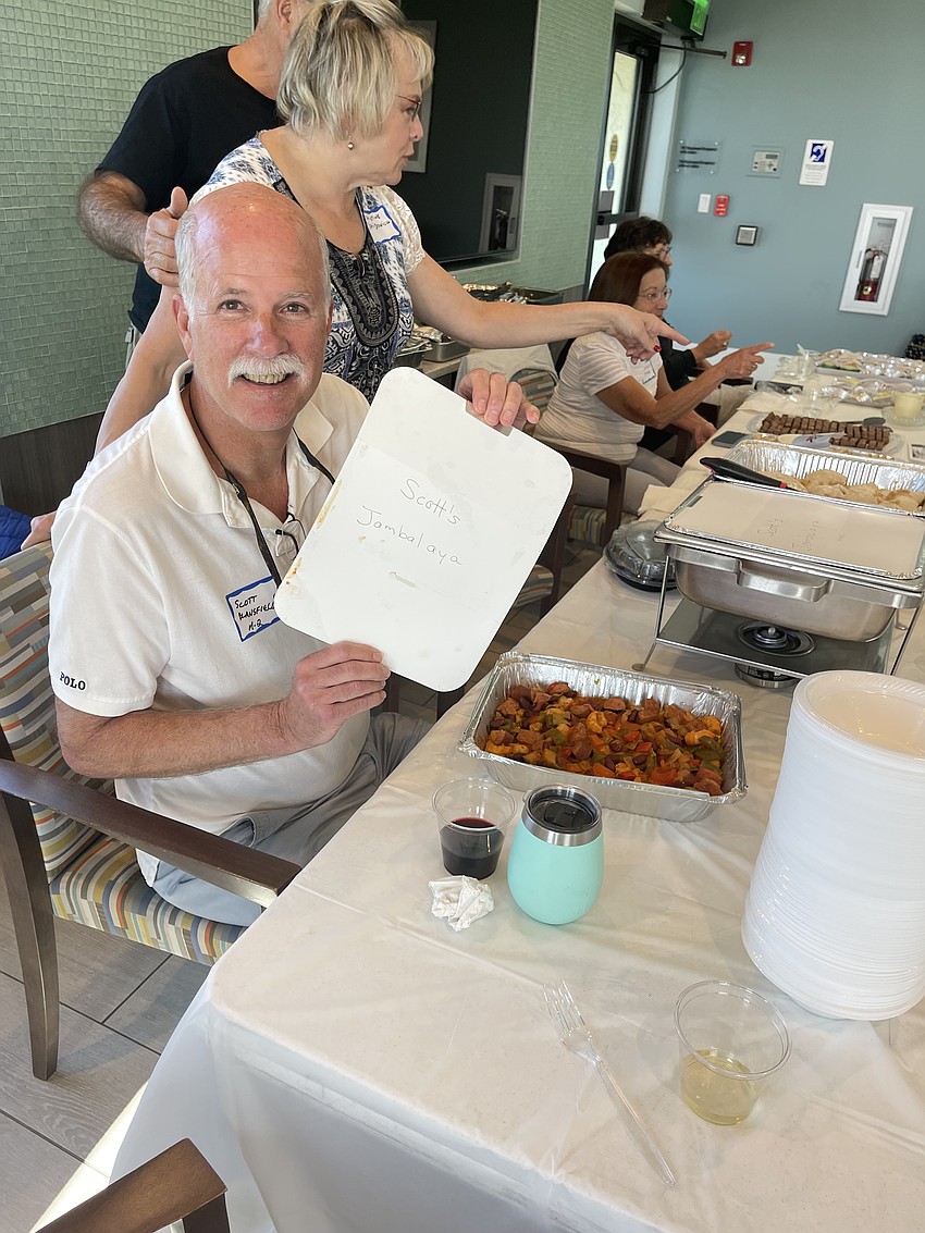Scott Blansfield takes the cover off his homemade jambalaya.