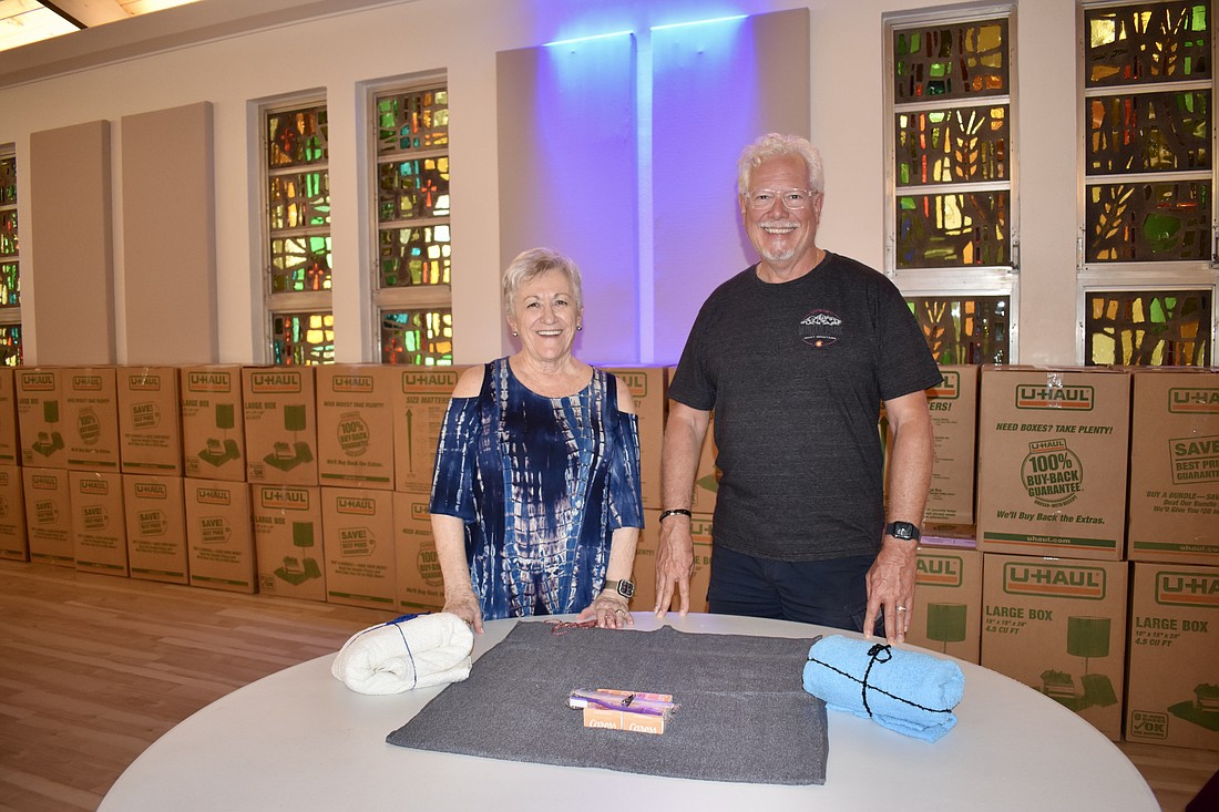 Ann Walborn and Ernie Smith volunteer to assemble care packages for Lutheral World Relief.