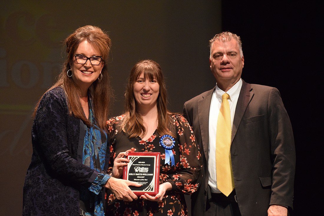 Cynthia Saunders, the superintendent of the School District of Manatee County, and Doug Wagner, the deputy superintendent of operations,  congratulate Kelly Smith-Williams (center), a Lakewood Ranch High School teacher, on being a finalist for Teacher of the Year.