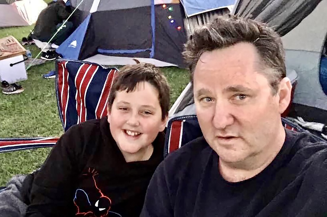 Greenbrook 13-year-old Drake Cohen settles into the campsite with his father, Tom Cohen, during Lakewood Ranch Community Activities' Community Campout.