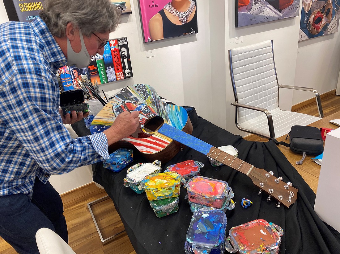 Bill Patterson paints a guitar for last year's Daytona 500. Courtesy photo