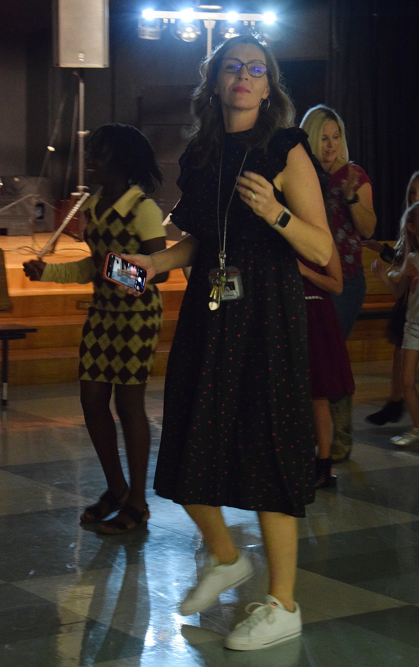 Laura Campbell, the principal of Tara Elementary School, leads students in the 