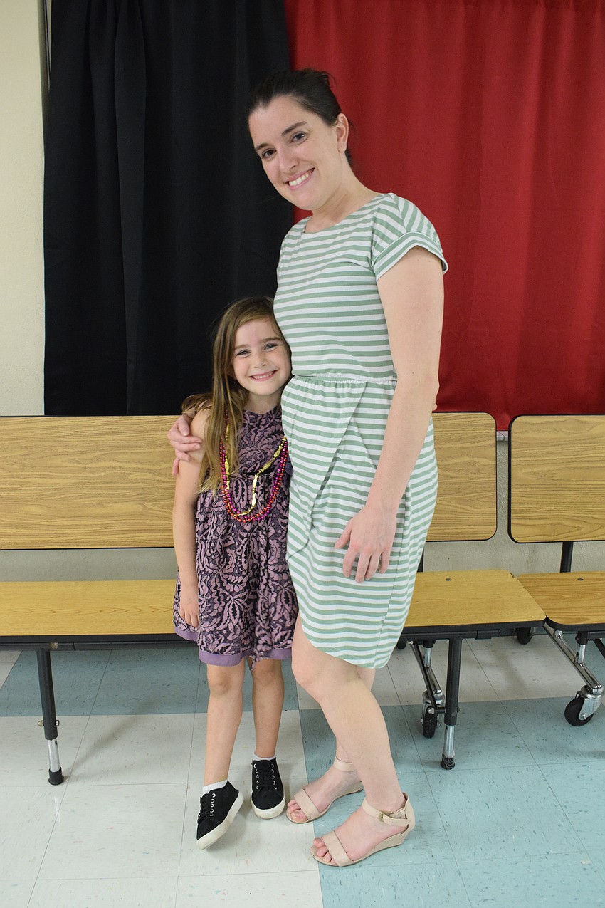 First grader Holland Whitlock and Katey Phipps take a break from the dance floor.