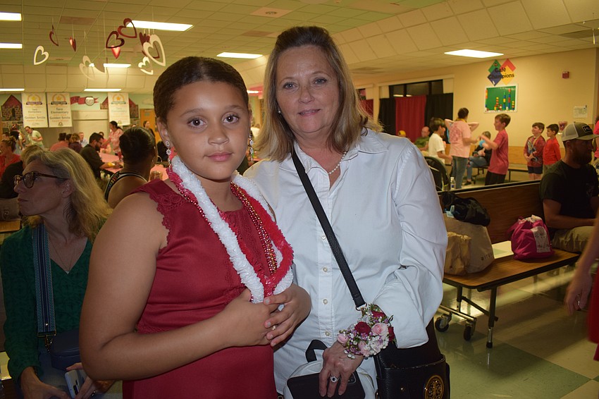 Third grader Payslie Hillman and Jennie Haldeman have a wonderful time at the sweetheart dance.