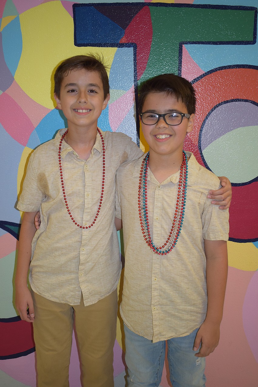 Fifth grader Tobias Guillermoni and his brother Francesco Guillermoni, who is in third grade, make their way to the dance floor.