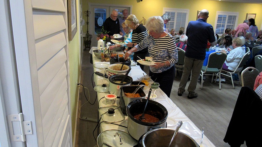 Carol Streinz samples the chili.