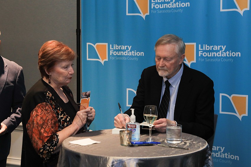 Erik Larson signs Alison Cutsinger's book during the VIP reception.