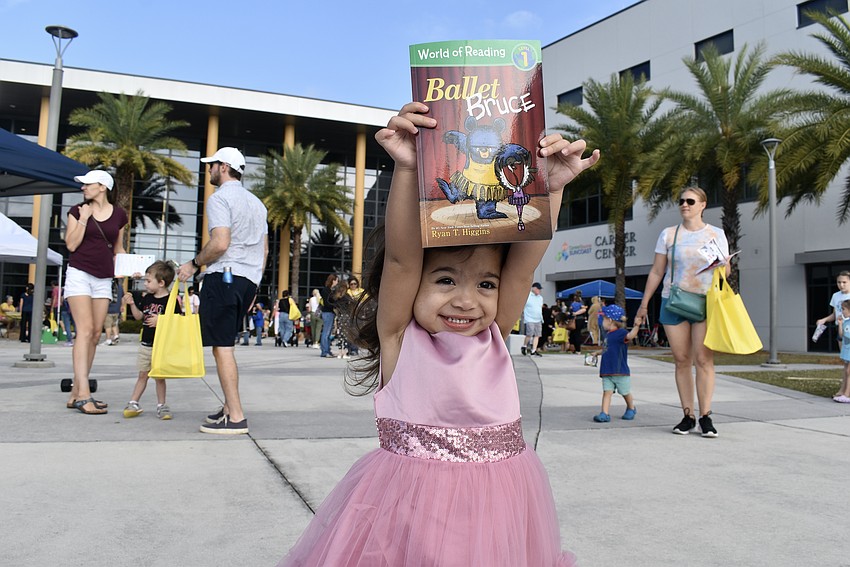 Isha Pramudyasworo picks up her book from the Sarasota Ballet booth.