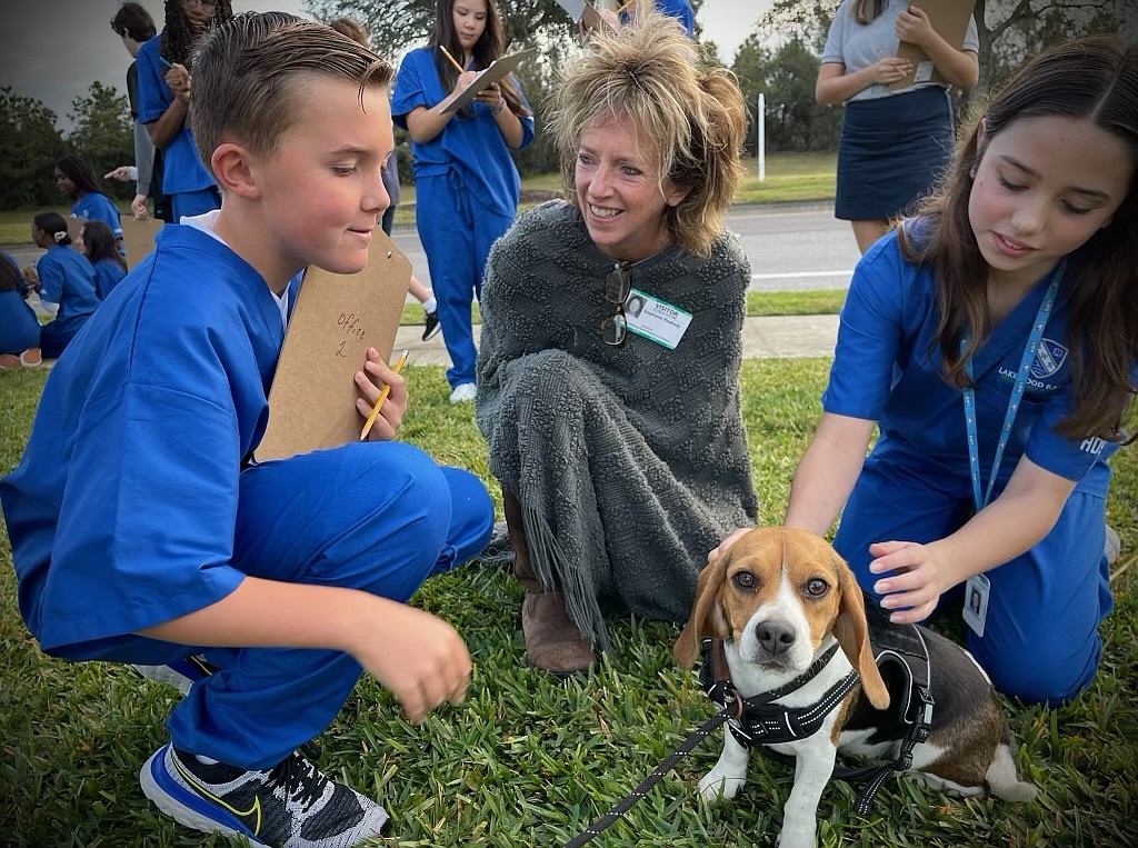 Lakewood Ranch Preparatory Academy sixth grader Ely Chappell conducts observational data collection with Stephanie Peabody, the founder of the Brain Health Initiative, and sixth grader Cadence Clay.