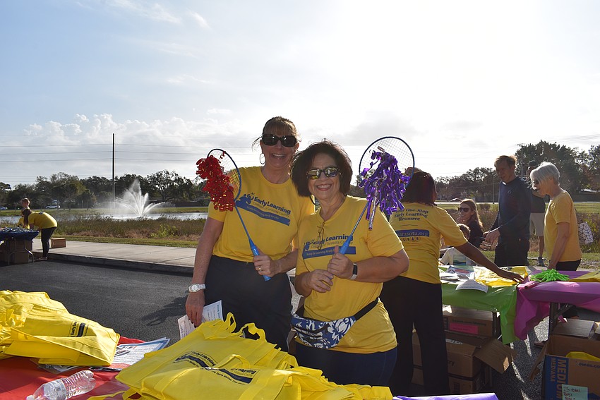 Kathy Cestaro and Jacky Velez hand out grab bags to families.