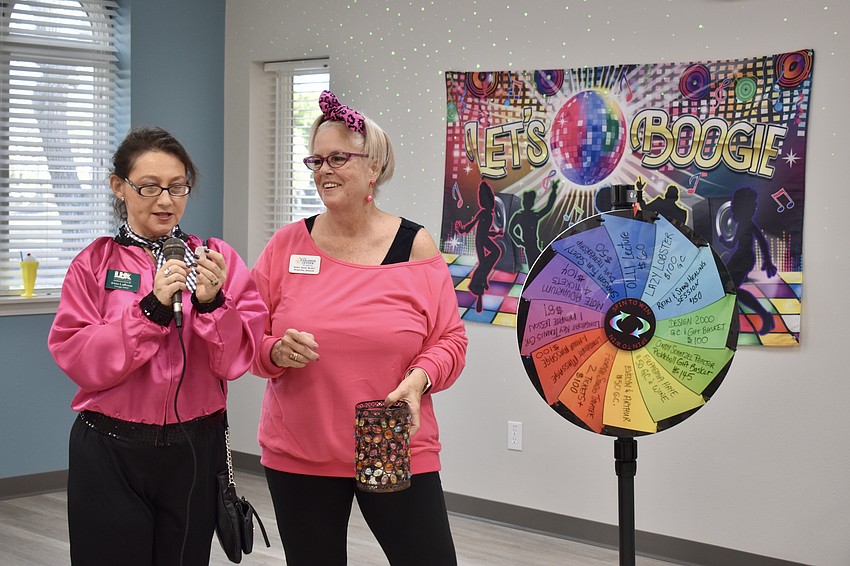 Irina LaRose and Donna Sharp Blaney pull raffle tickets.