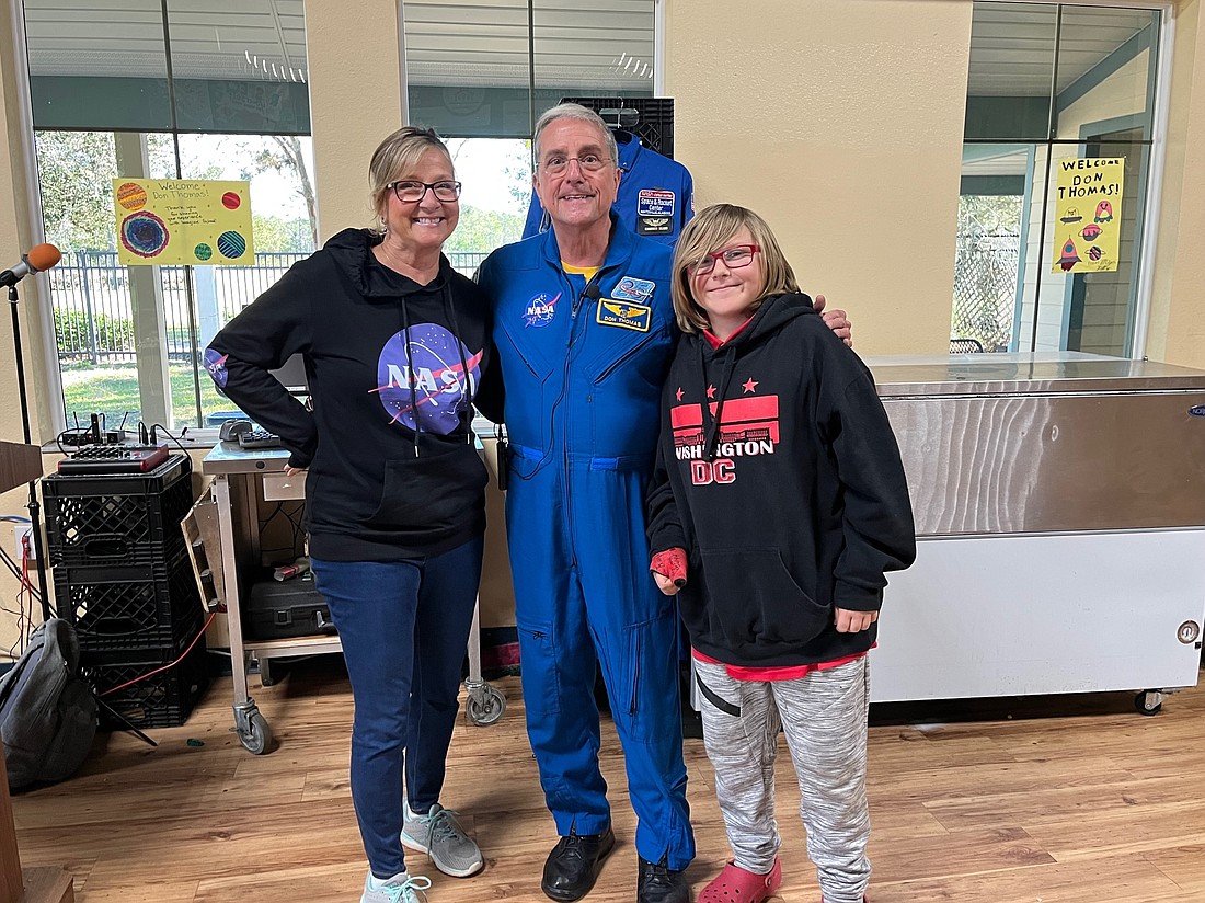 Imagine School at Town Center seventh grade science teacher Joan Soldano with astronaut Don Thomas and seventh grader Caleb Kempfer. Courtesy photo